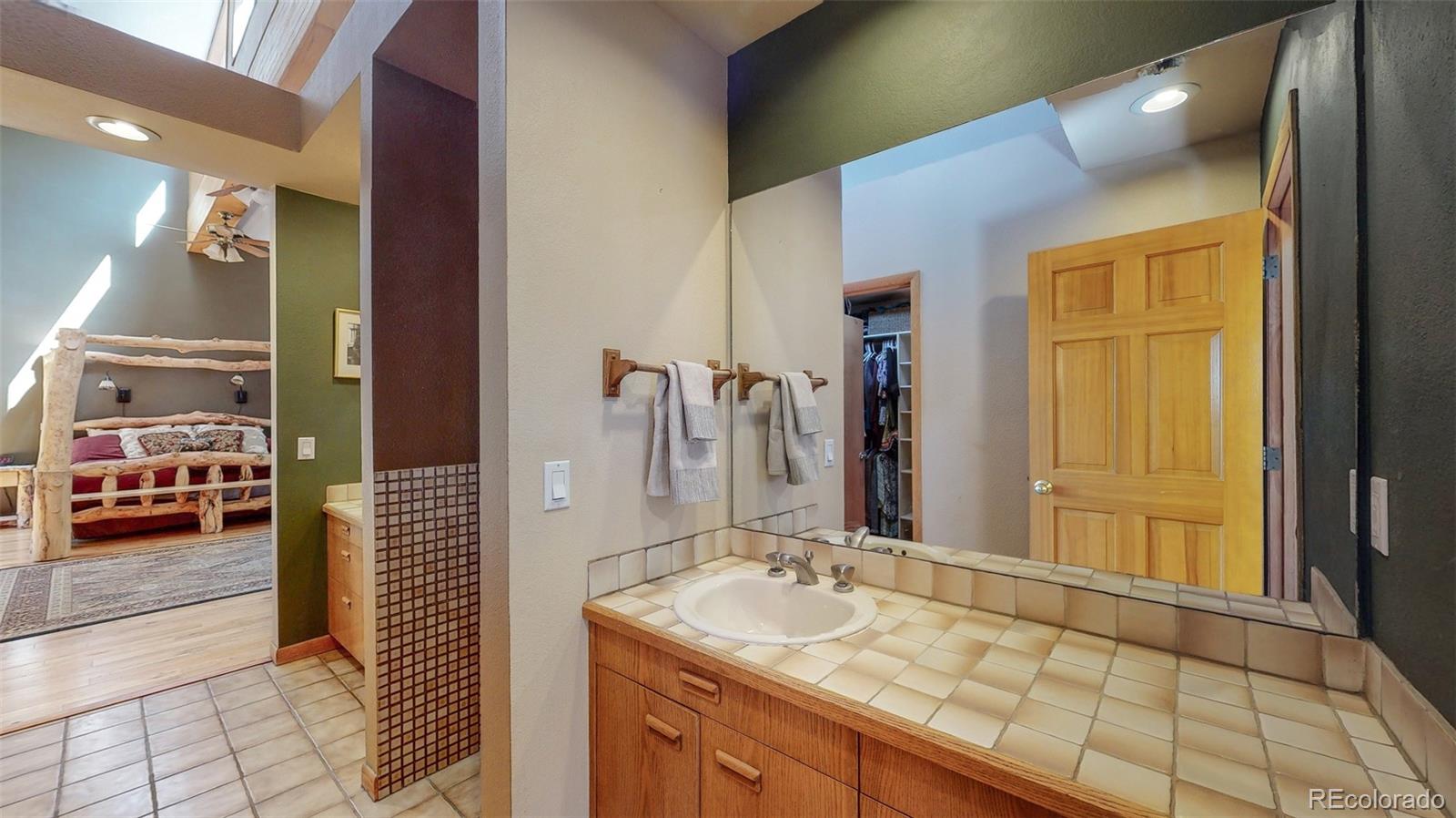 2720 South Spring Gulch Road Idaho Springs, CO 80452 - Photo 19 of 38 a bathroom with a sink and a mirror
