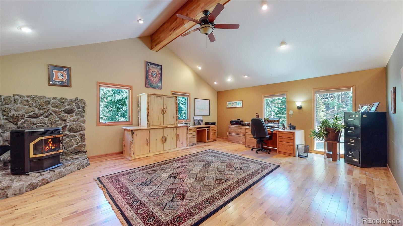 2720 South Spring Gulch Road Idaho Springs, CO 80452 - Photo 23 of 38 a living room with furniture and a fireplace
