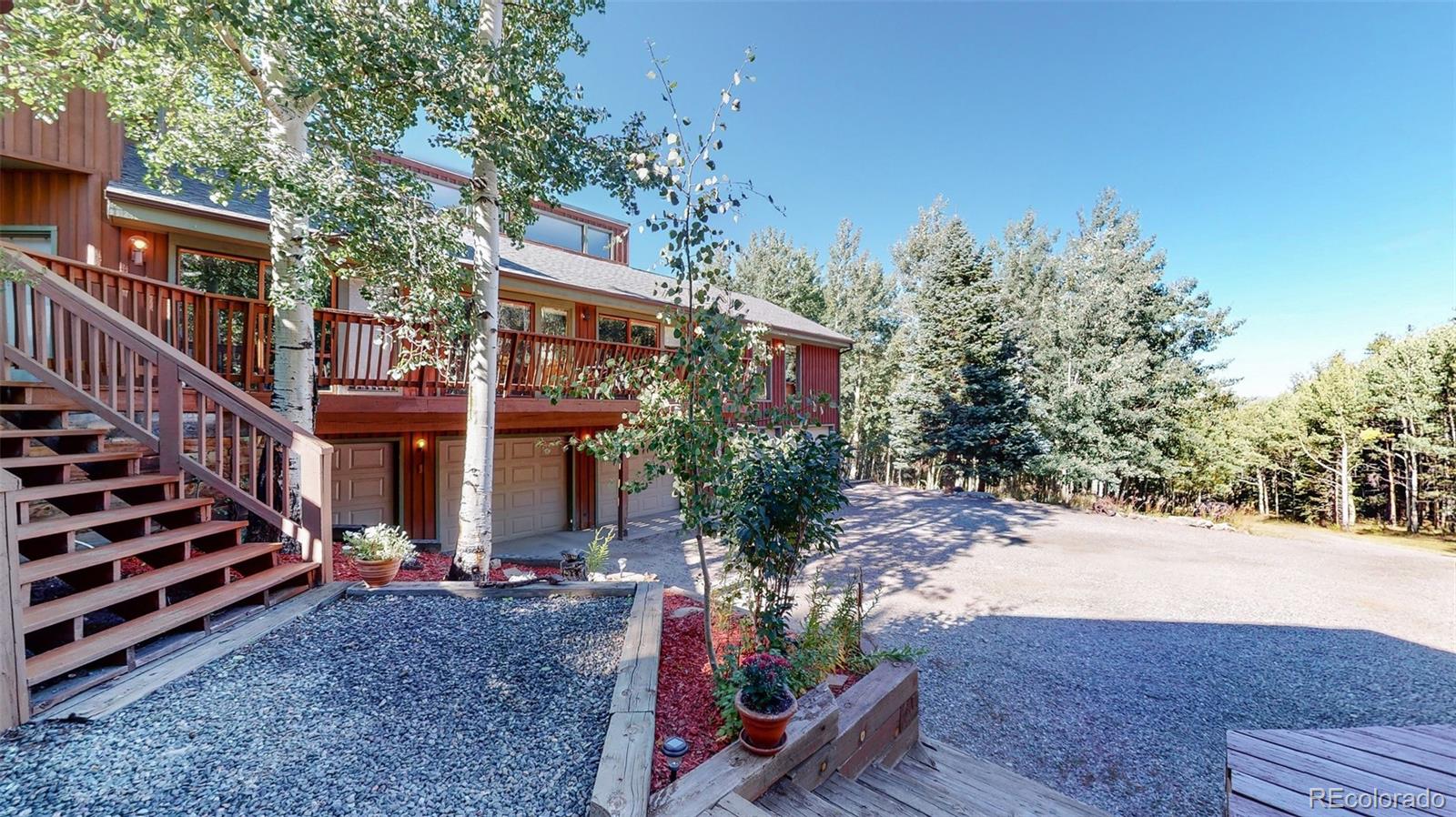 2720 South Spring Gulch Road Idaho Springs, CO 80452 - Photo 28 of 38 a view of a house with a yard and pathway