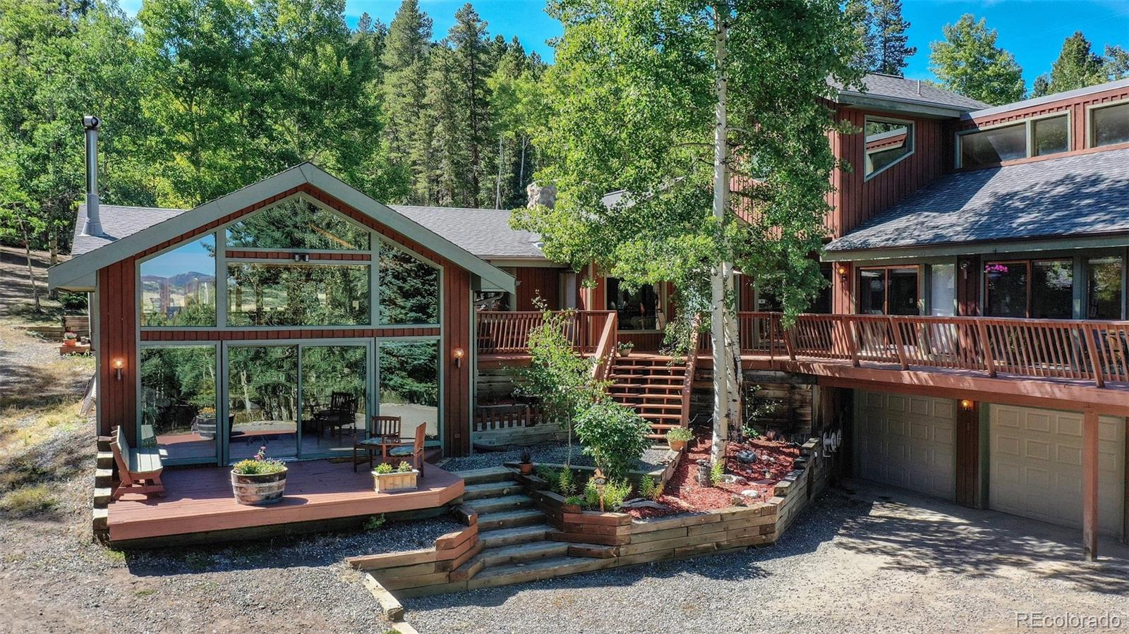 2720 South Spring Gulch Road Idaho Springs, CO 80452 - Photo 31 of 38 a backyard of a house with yard barbeque oven and outdoor seating