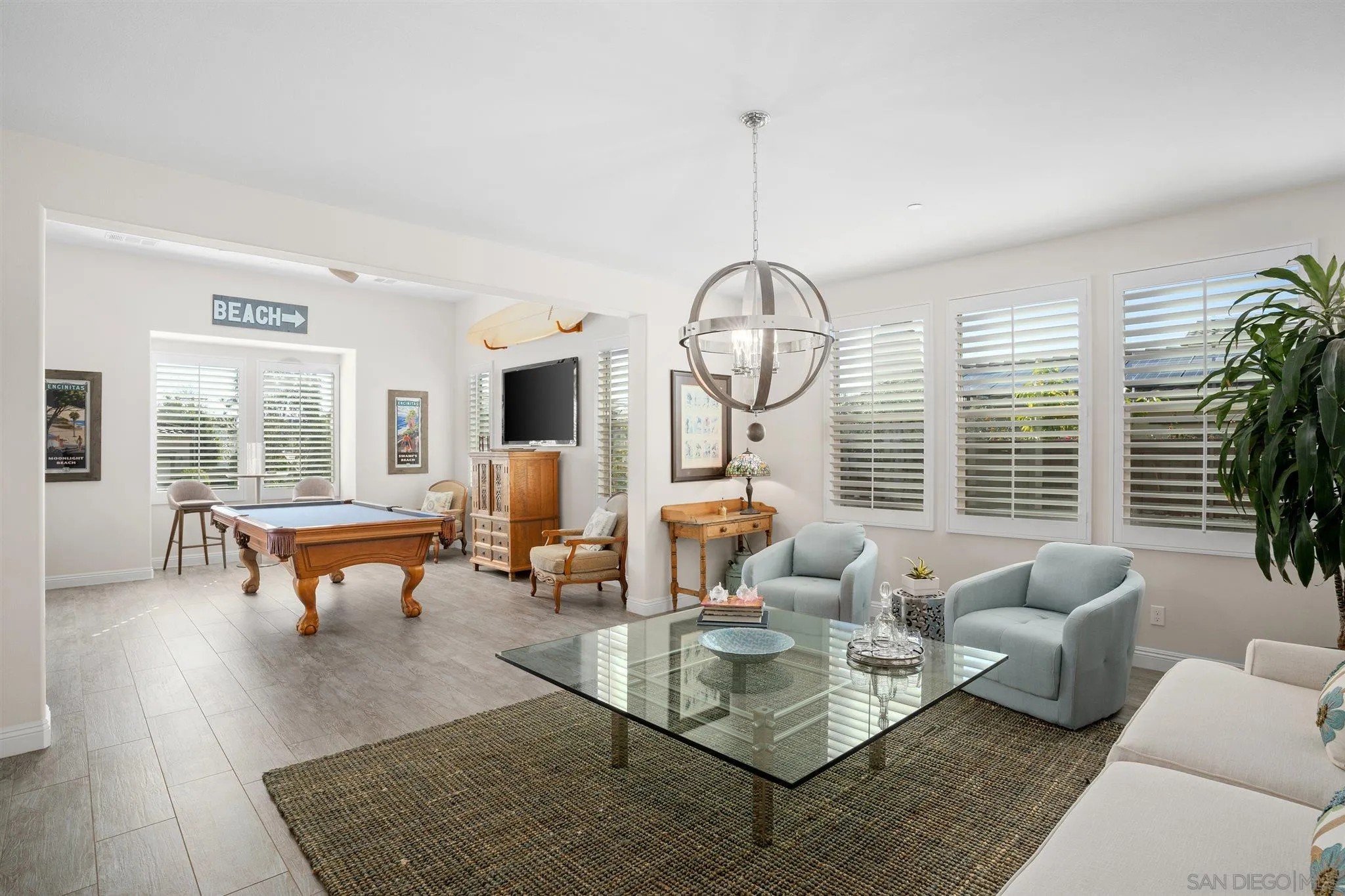 700 Blossom Road Encinitas, CA 92024 - Photo 15 of 50 a living room with fireplace chandelier and window