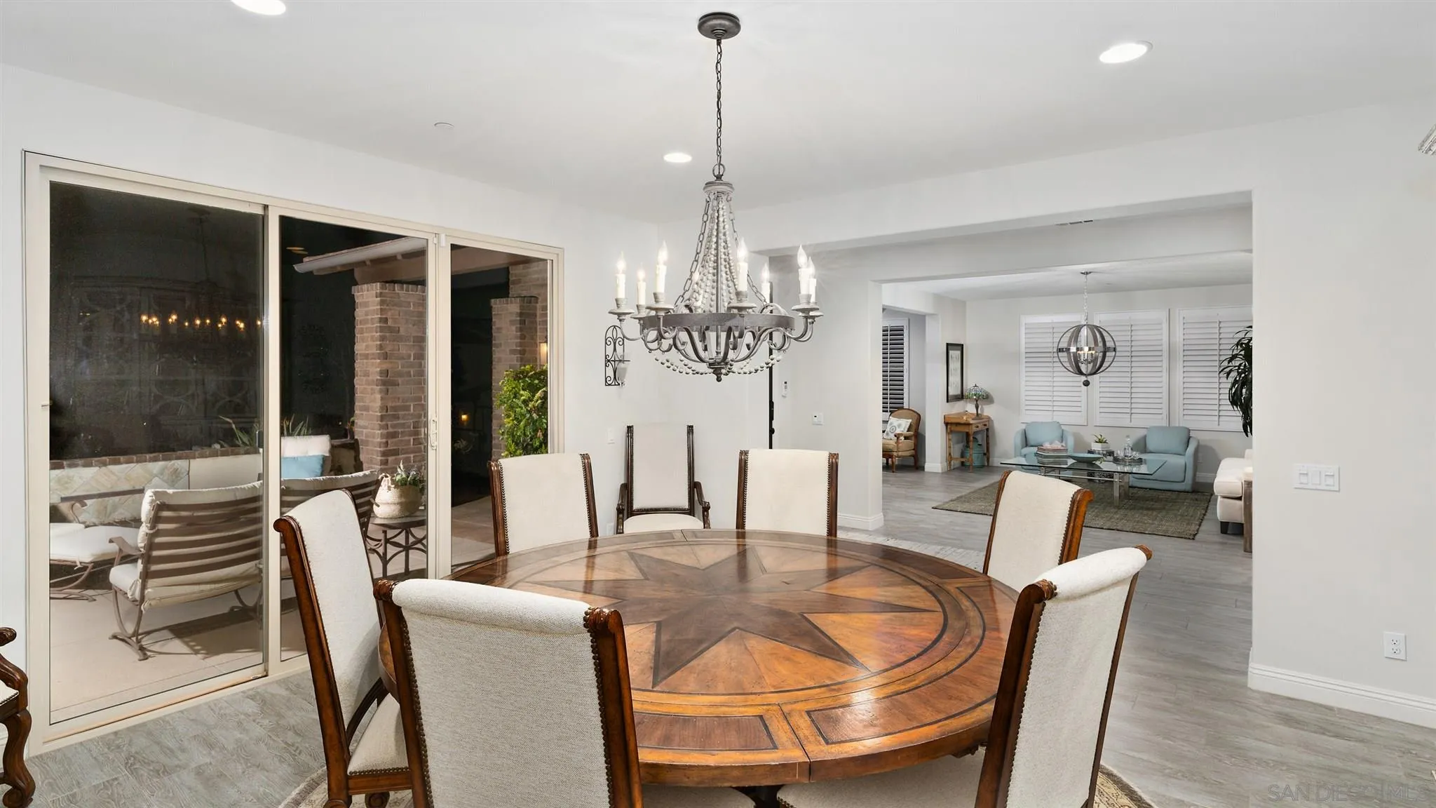 700 Blossom Road Encinitas, CA 92024 - Photo 17 of 50 a dining room with furniture a chandelier and wooden floor