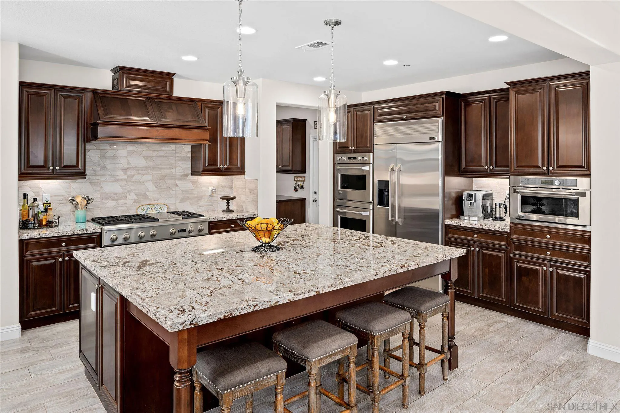 700 Blossom Road Encinitas, CA 92024 - Photo 19 of 50 a kitchen with stainless steel appliances granite countertop a stove refrigerator sink and cabinets