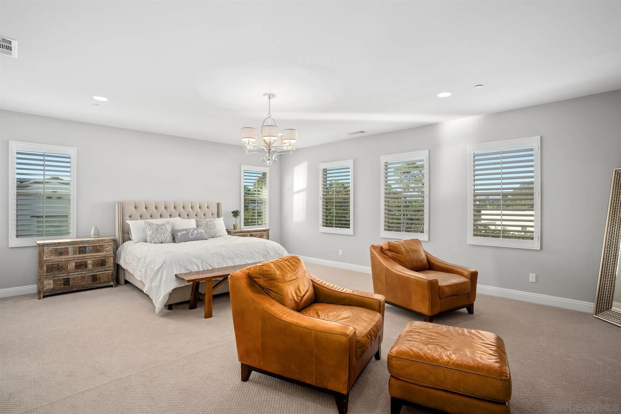 700 Blossom Road Encinitas, CA 92024 - Photo 22 of 50 a spacious bedroom with furniture and a couch