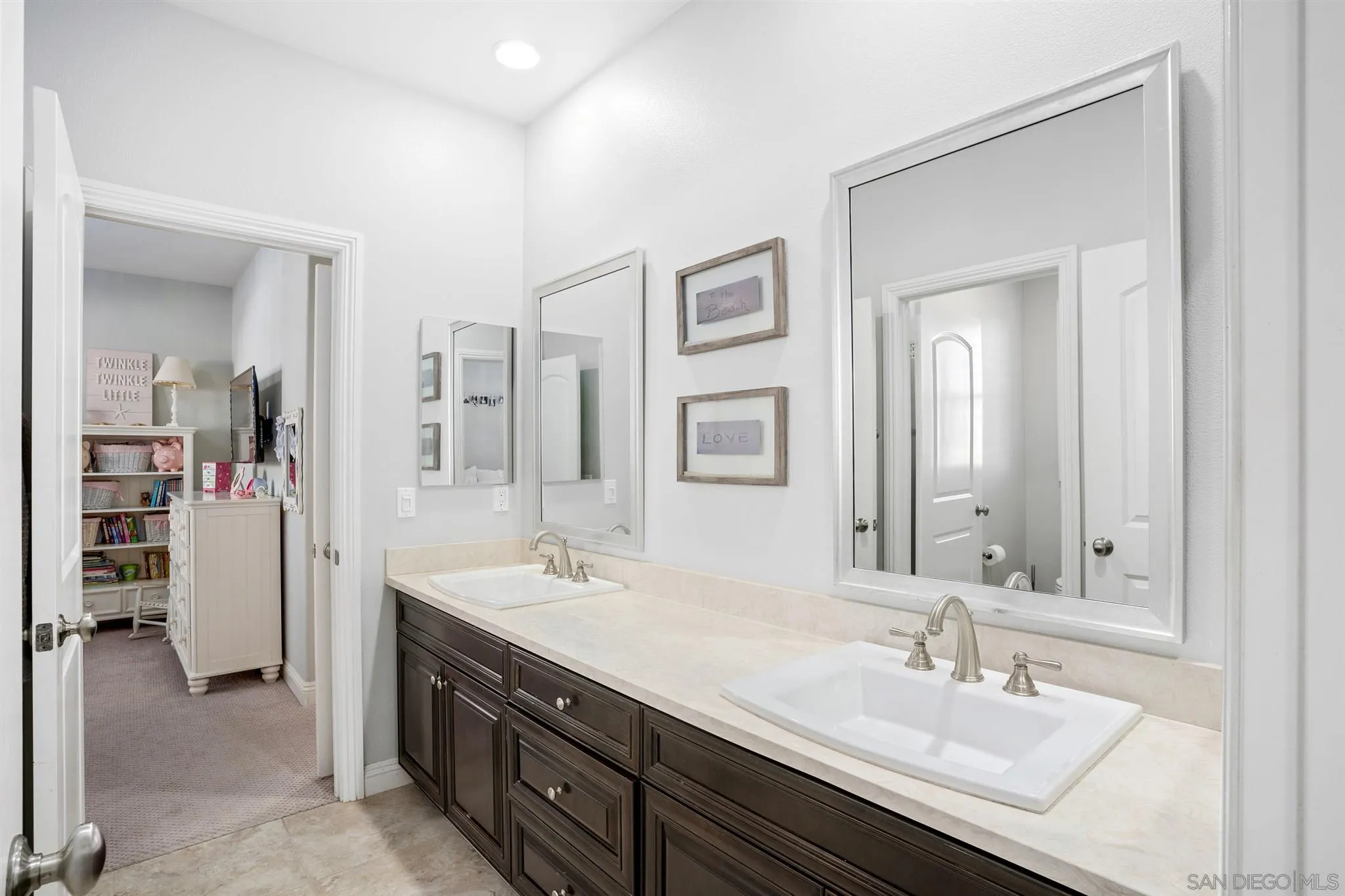 700 Blossom Road Encinitas, CA 92024 - Photo 36 of 50 a bathroom with a sink double vanity and a mirror