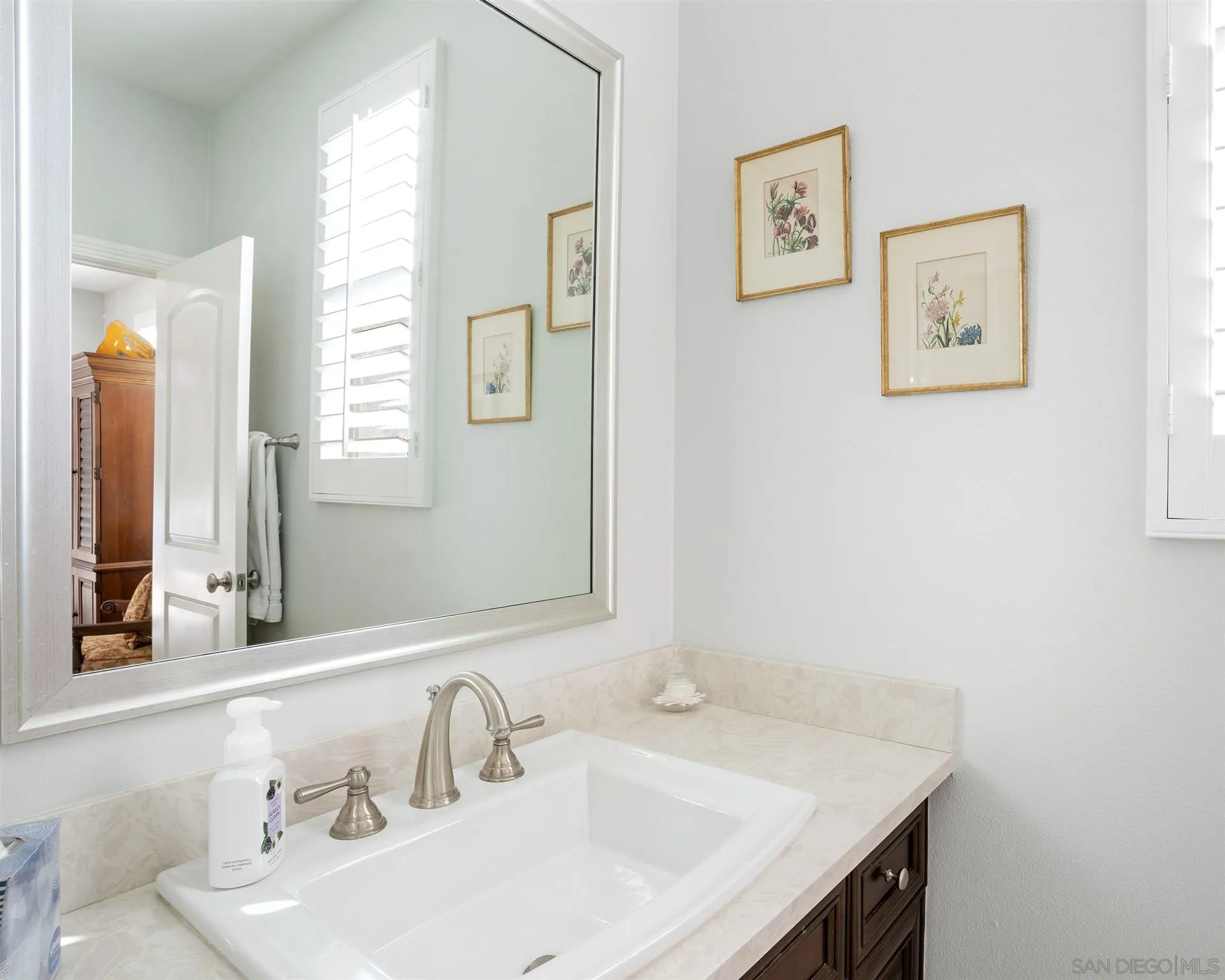 700 Blossom Road Encinitas, CA 92024 - Photo 40 of 50 a bathroom with a sink and a mirror