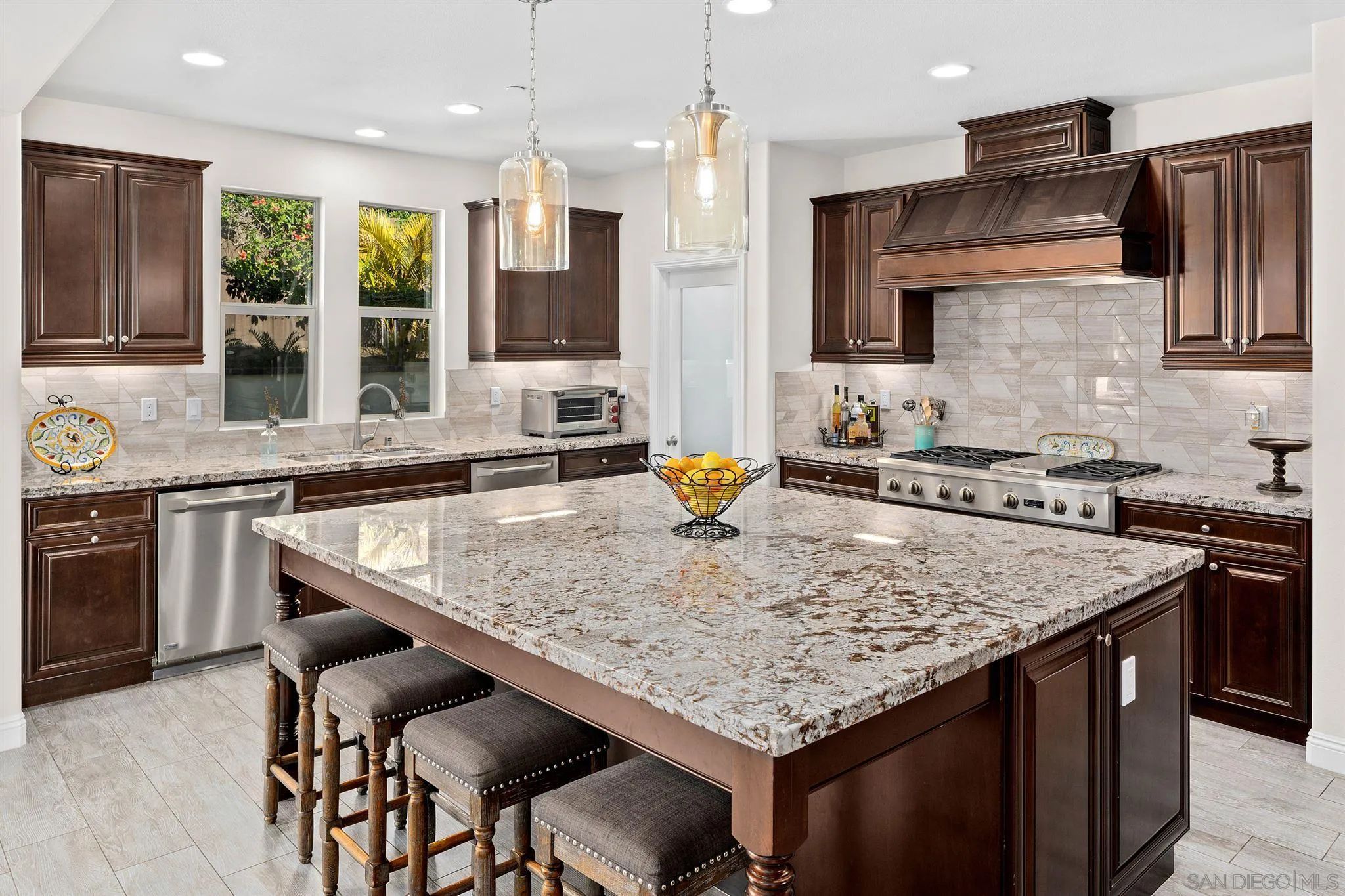 700 Blossom Road Encinitas, CA 92024 - Photo 42 of 50 a kitchen with granite countertop kitchen island stainless steel appliances a sink stove and oven