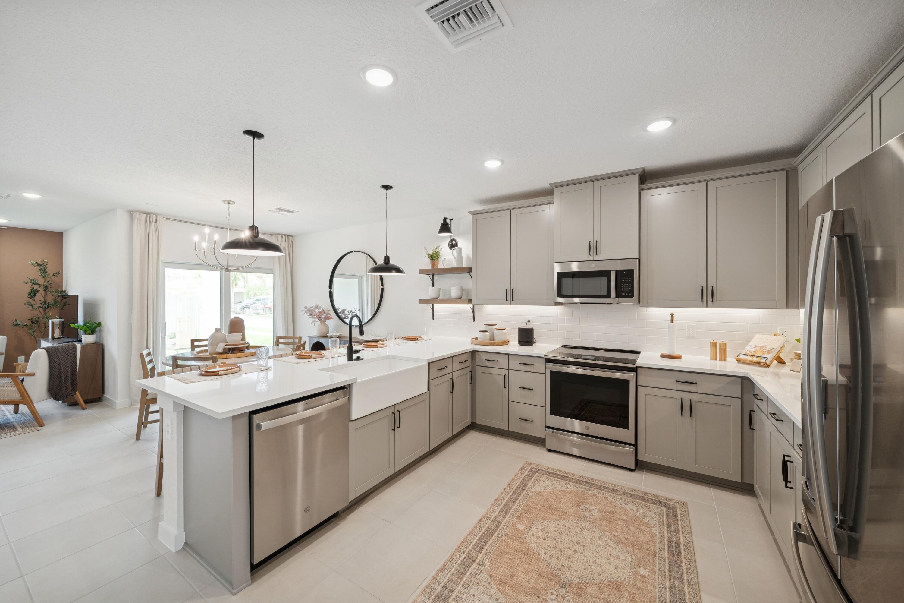 9736 Apollo Avenue, Unit 3 Fort Pierce, FL 34945 - Photo 18 of 39 a kitchen with appliances a sink and cabinets