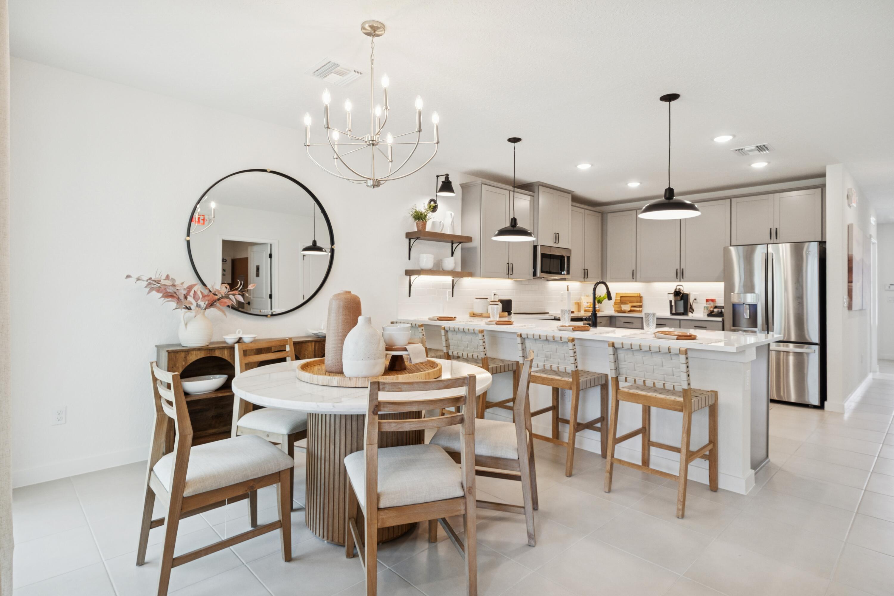 9736 Apollo Avenue, Unit 3 Fort Pierce, FL 34945 - Photo 23 of 39 a dining room with kitchen island a dining table and chairs