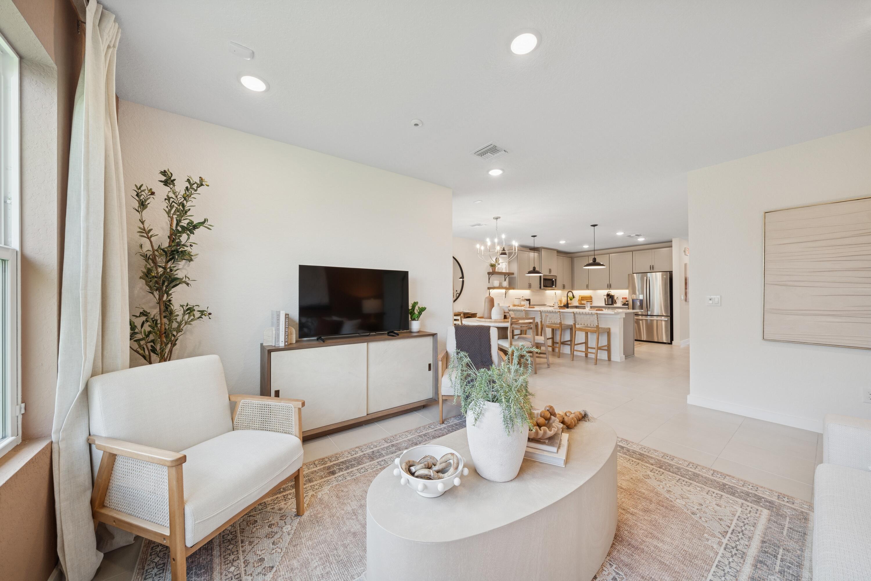 9736 Apollo Avenue, Unit 3 Fort Pierce, FL 34945 - Photo 27 of 39 a living room with furniture and a flat screen tv
