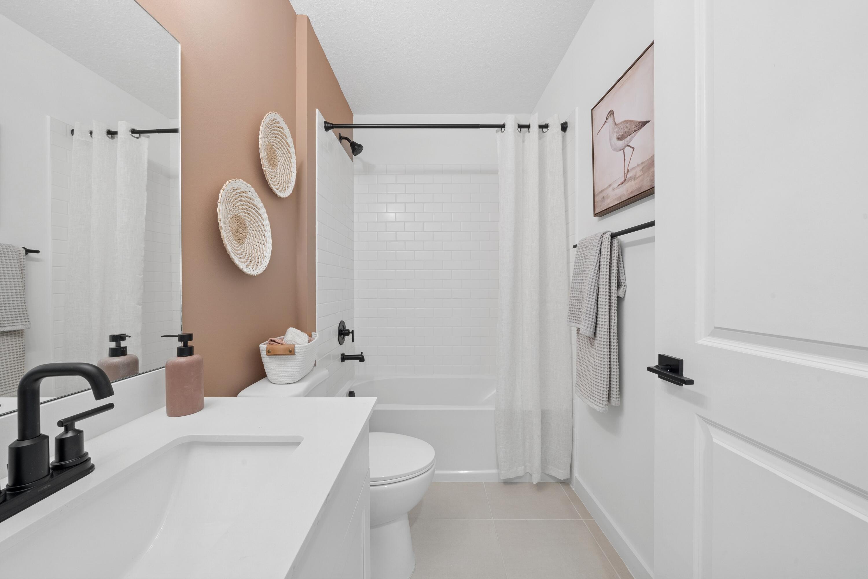 9736 Apollo Avenue, Unit 3 Fort Pierce, FL 34945 - Photo 8 of 39 a bathroom with a sink a toilet and shower