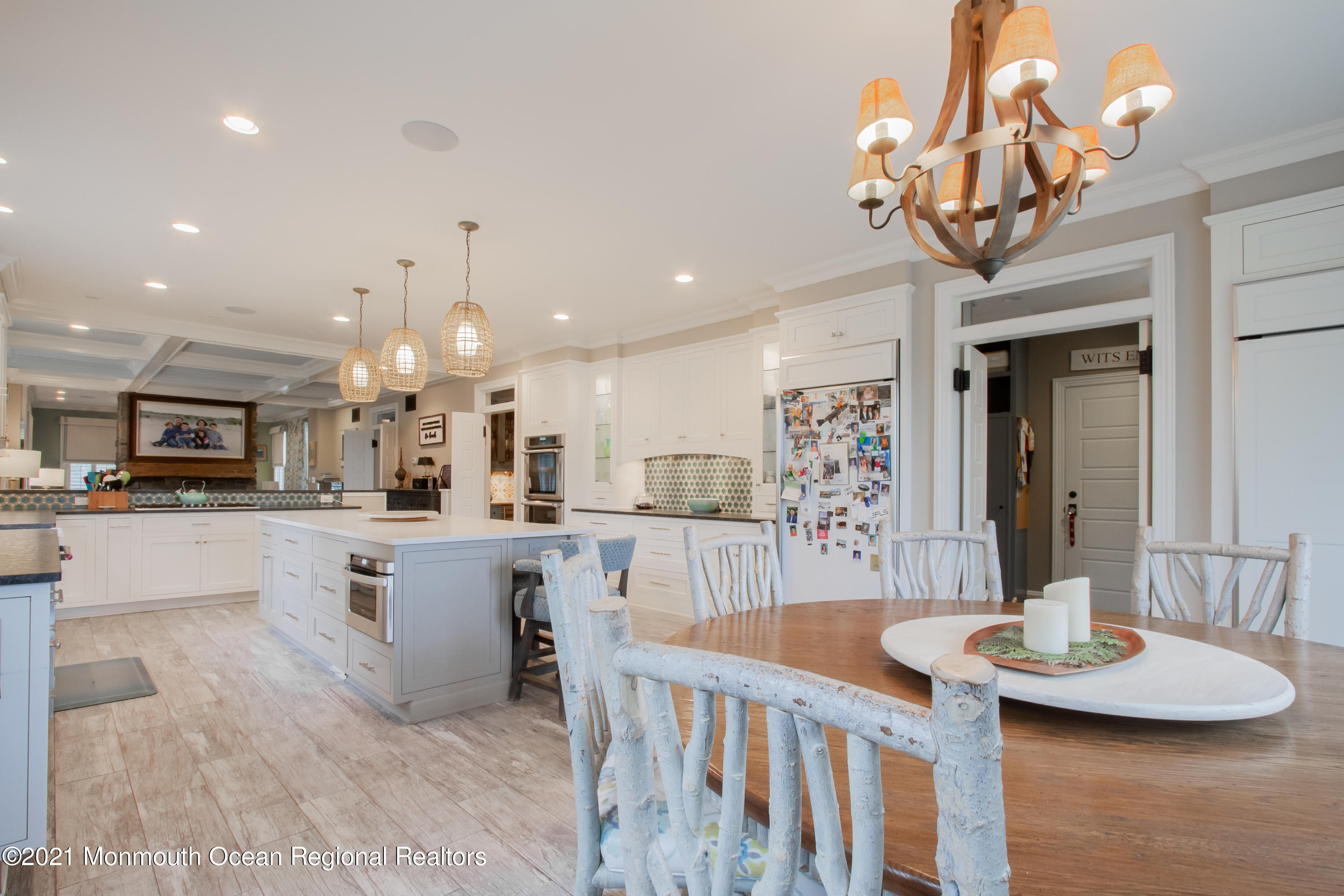 451 Little Silver Point Road Little Silver, NJ 07739 - Photo 21 of 63 a kitchen with stainless steel appliances kitchen island granite countertop a sink dishwasher a dining table and chairs with wooden floor