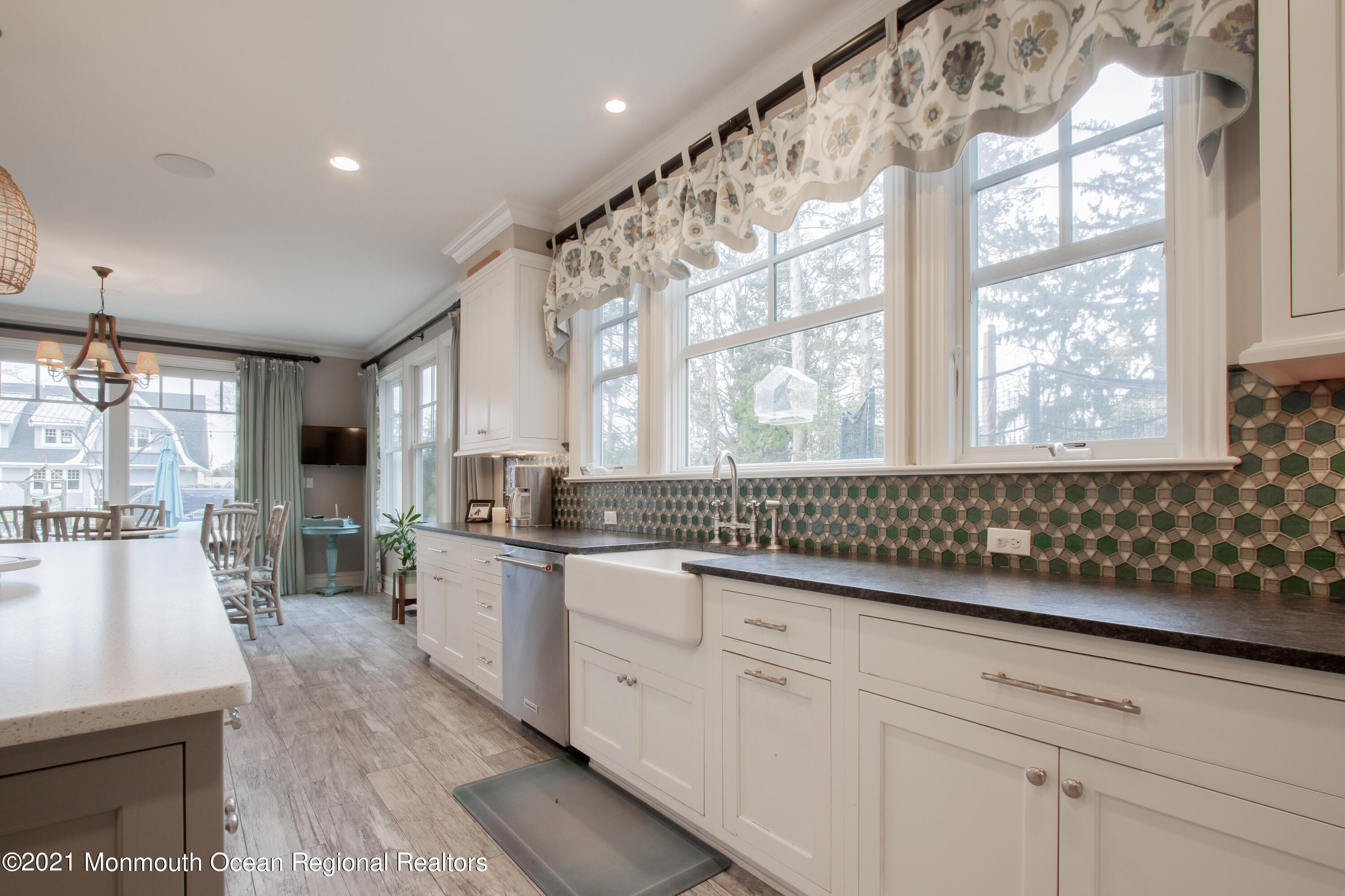 451 Little Silver Point Road Little Silver, NJ 07739 - Photo 22 of 63 a kitchen with stainless steel appliances white cabinets a stove a sink and a large window