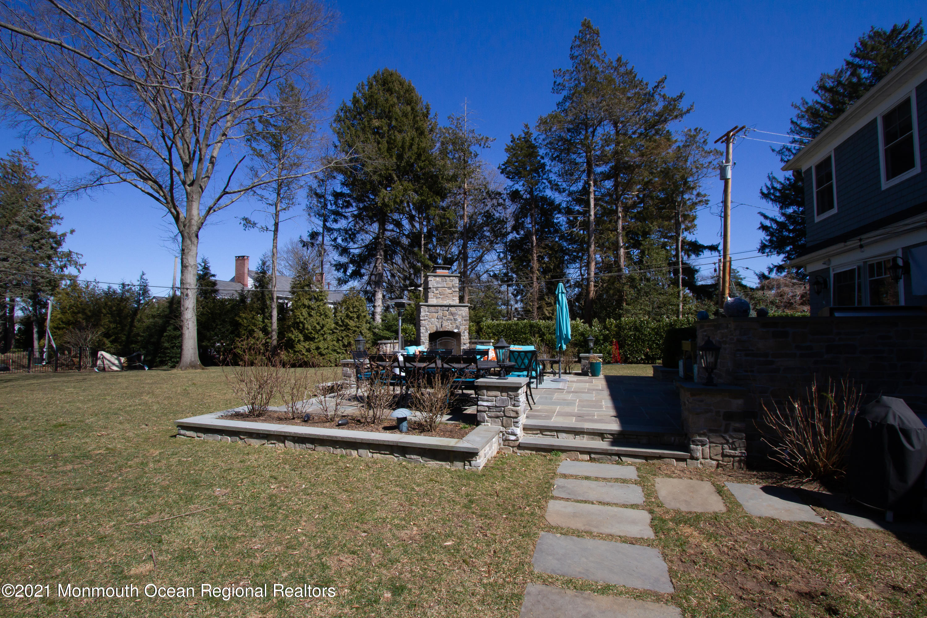451 Little Silver Point Road Little Silver, NJ 07739 - Photo 56 of 63 a view of the patio with dining table and chairs with a fire pit