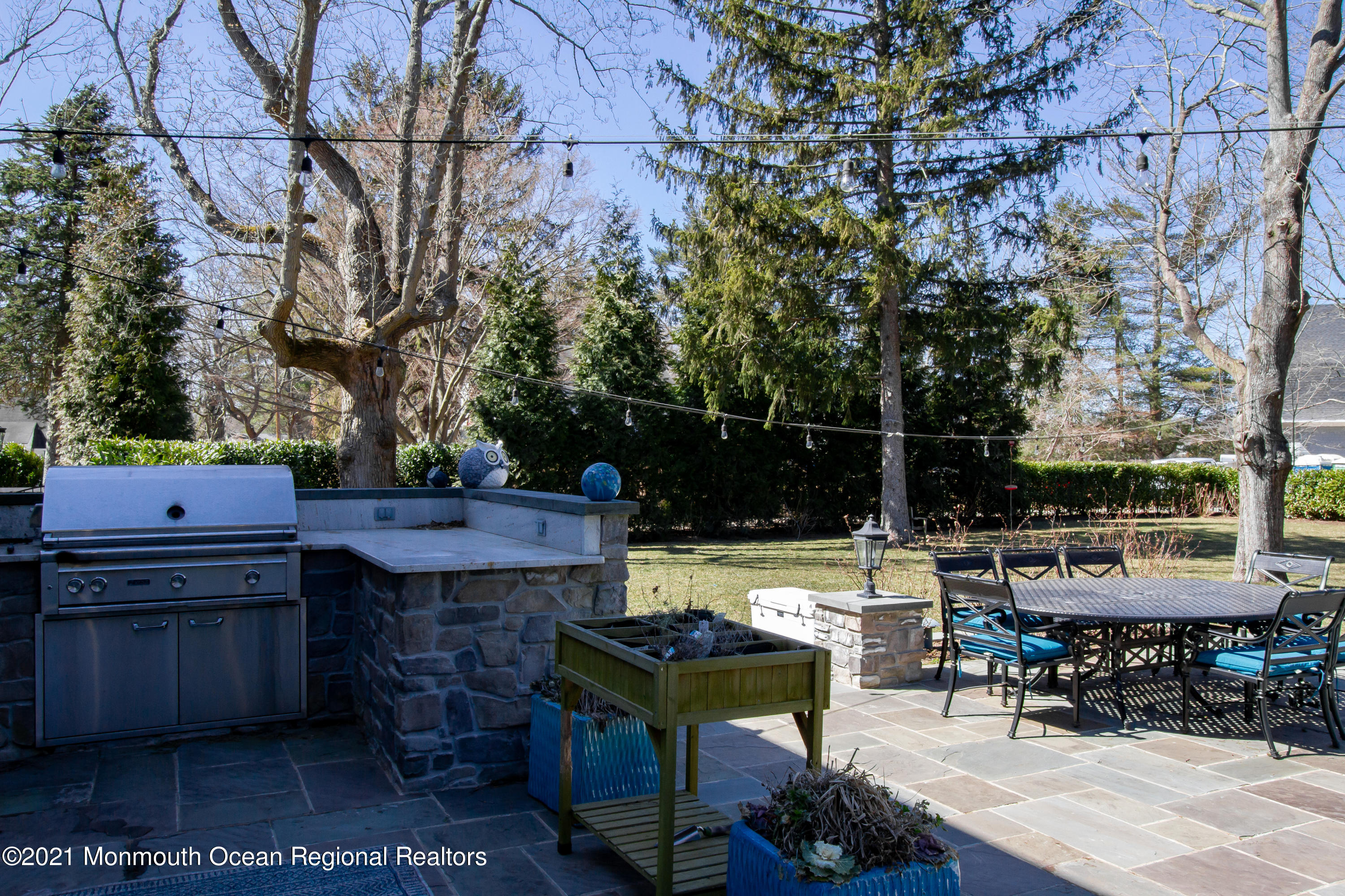 451 Little Silver Point Road Little Silver, NJ 07739 - Photo 59 of 63 a view of a patio with table and chairs potted plants and a large tree