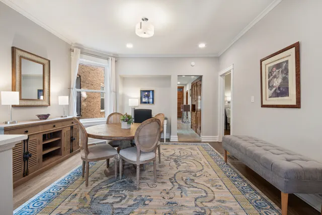a living room with furniture two windows and a stove
