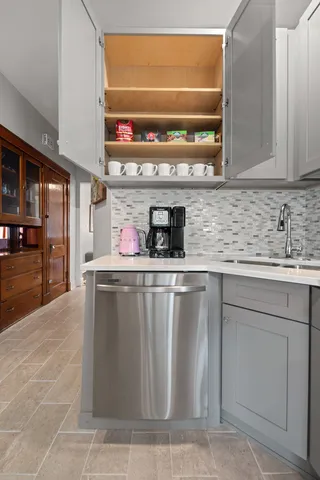 a kitchen with stainless steel appliances a sink and cabinets