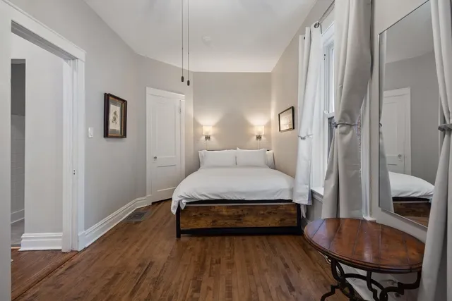 a bedroom with a bed and a chair