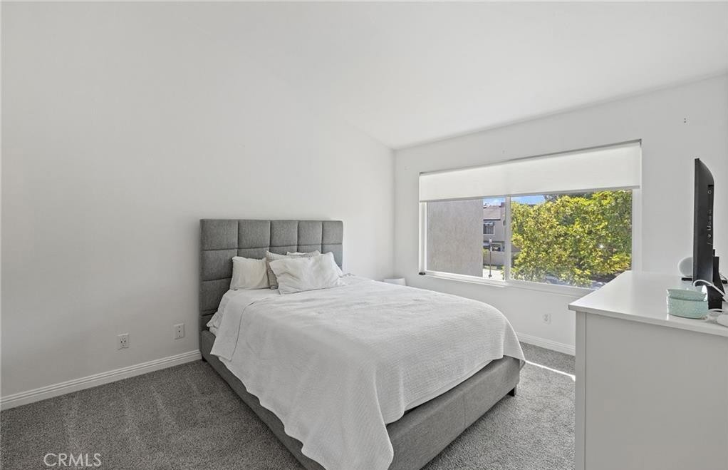 164 Stanford Court, Unit 82 Irvine, CA 92612 - Photo 16 of 34 a bedroom with a bed and a flat screen tv