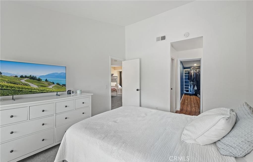 164 Stanford Court, Unit 82 Irvine, CA 92612 - Photo 17 of 34 a bedroom with a bed and a dresser