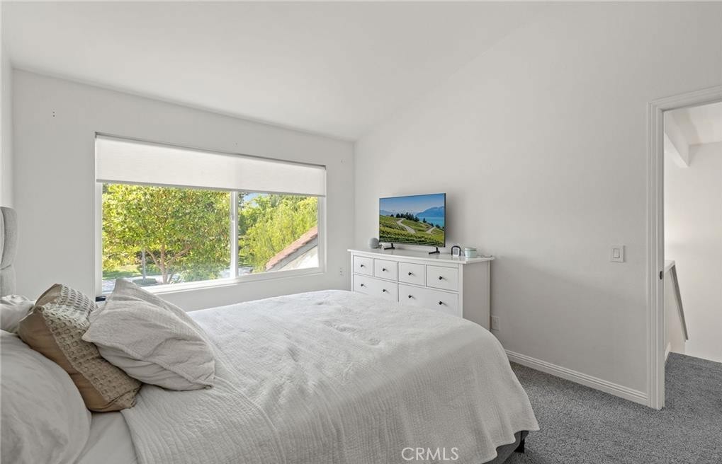 164 Stanford Court, Unit 82 Irvine, CA 92612 - Photo 19 of 34 a bedroom with a bed and large window