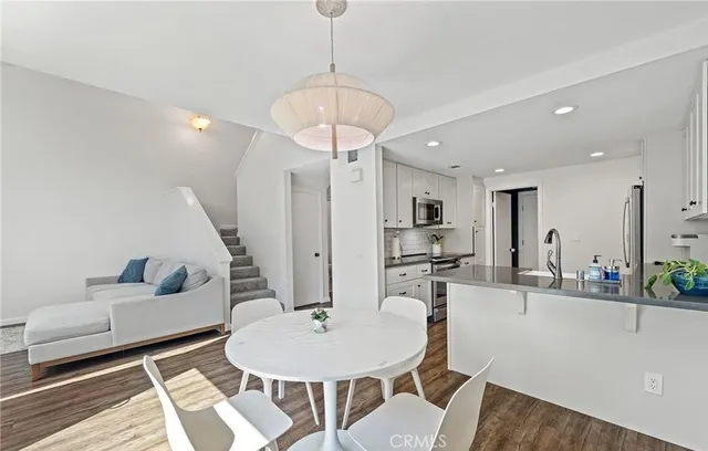 a living room with furniture and kitchen view