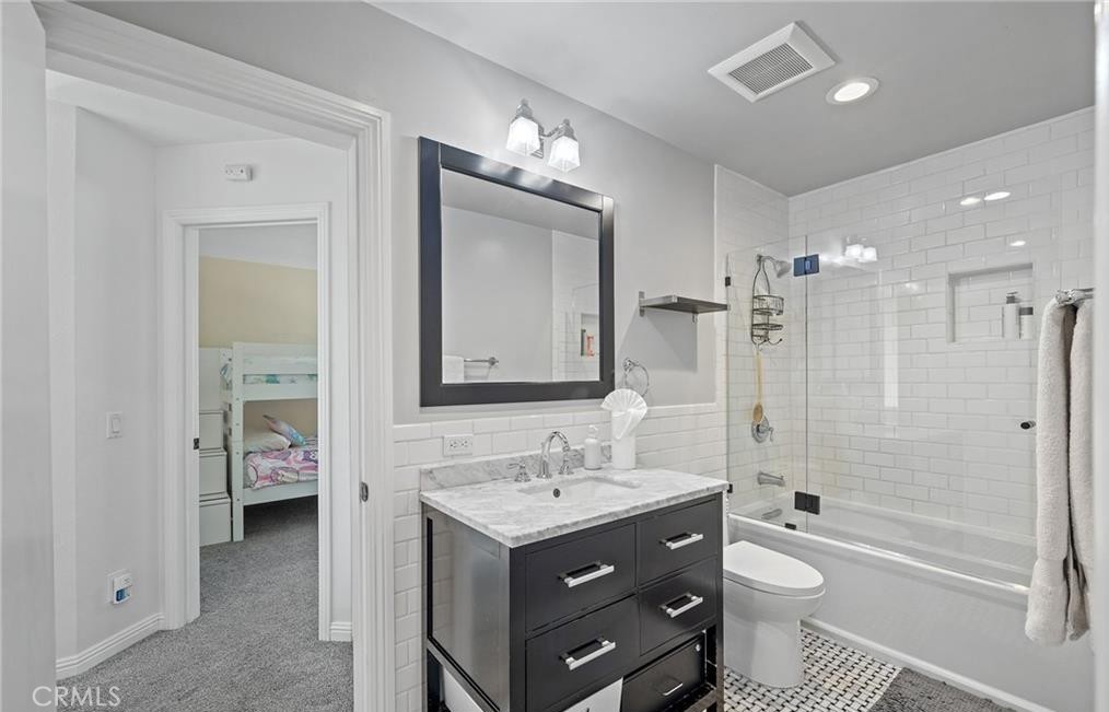 164 Stanford Court, Unit 82 Irvine, CA 92612 - Photo 21 of 34 a bathroom with a tub a toilet double sink and shower