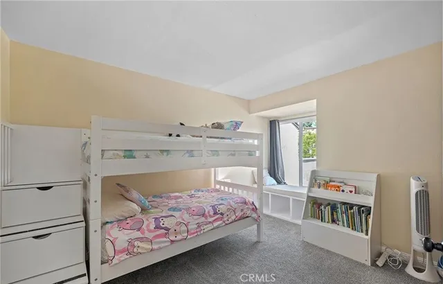 a bedroom with a bed and a book shelf