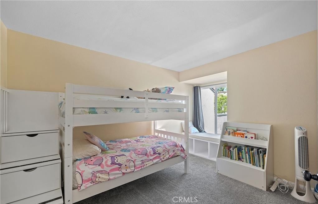 164 Stanford Court, Unit 82 Irvine, CA 92612 - Photo 24 of 34 a bedroom with a bed and a book shelf