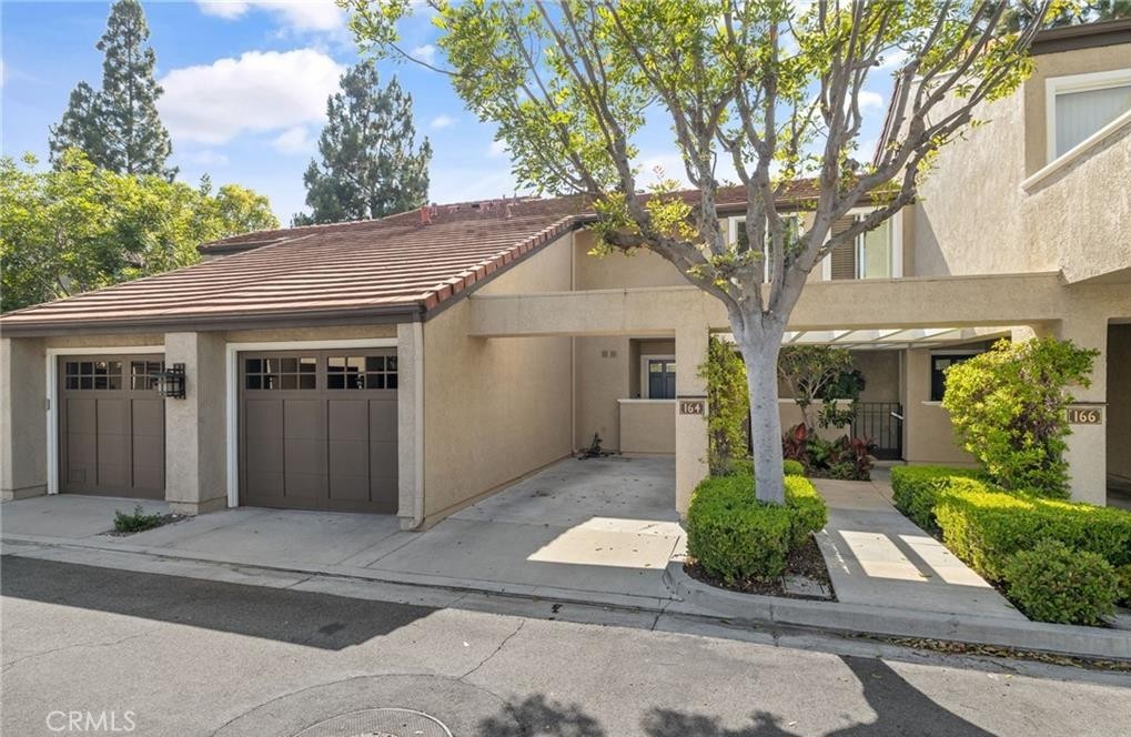 164 Stanford Court, Unit 82 Irvine, CA 92612 - Photo 27 of 34 a front view of a house with garden
