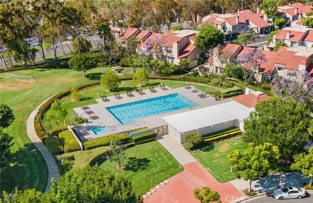 an aerial view of residential houses with outdoor space and lake view