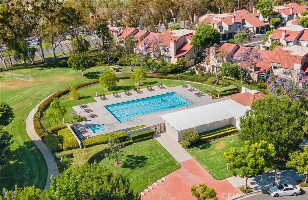 164 Stanford Court, Unit 82 Irvine, CA 92612 - Photo 33 of 34 an aerial view of a house with a garden and swimming pool
