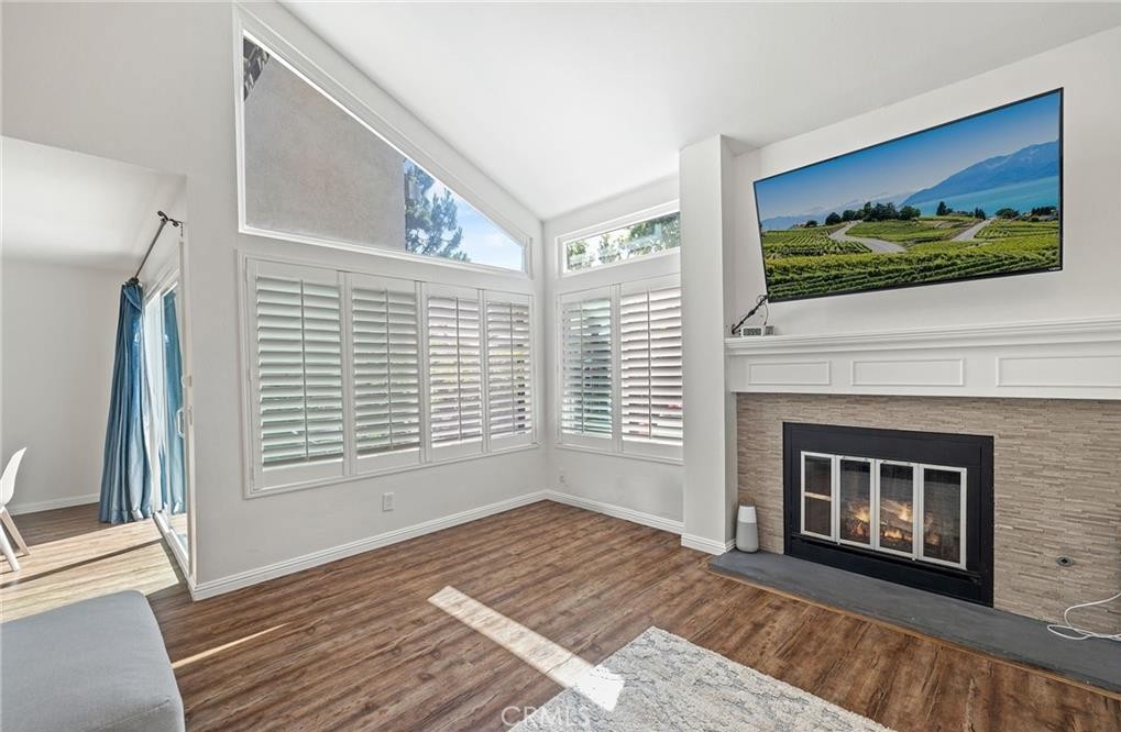 164 Stanford Court, Unit 82 Irvine, CA 92612 - Photo 4 of 34 a view of an empty room with wooden floor and a window