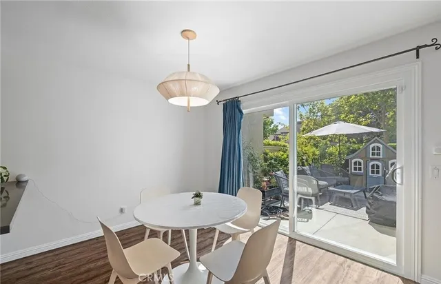 a view of a dining room with furniture wooden floor and chandelier