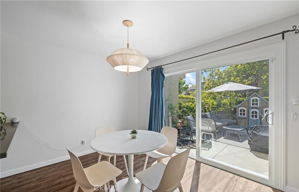 164 Stanford Court, Unit 82 Irvine, CA 92612 - Photo 8 of 34 a view of a dining room with furniture wooden floor and chandelier