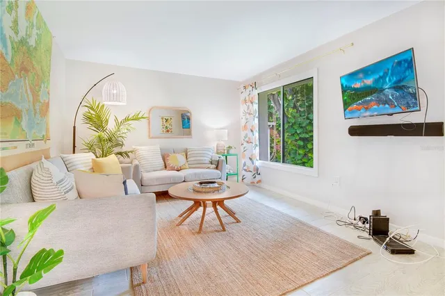 a living room with furniture a rug and a painting on the wall
