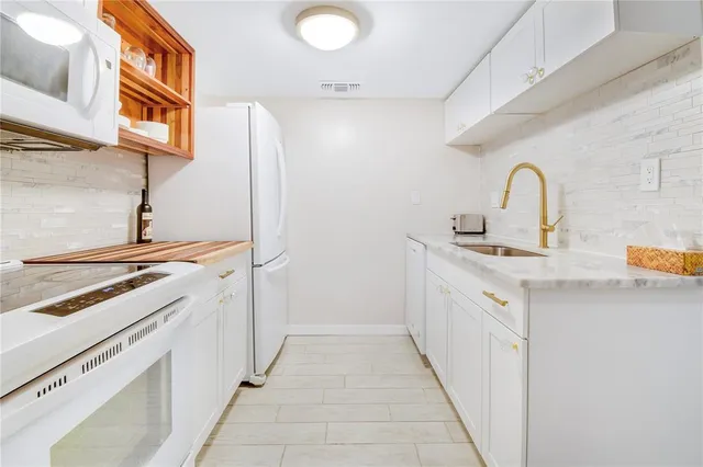 a kitchen with a sink and a stove top oven