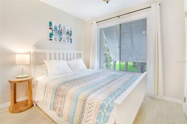 a bedroom with a bed and a painting on the wall