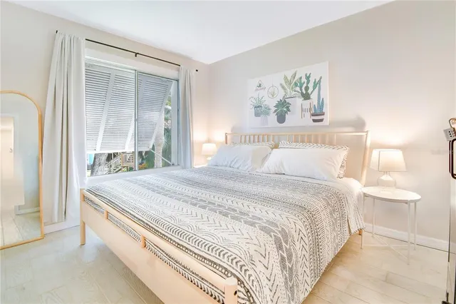 a bedroom with a bed and a painting on the wall