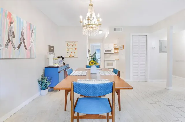 a view of a dining room with furniture and a chandelier