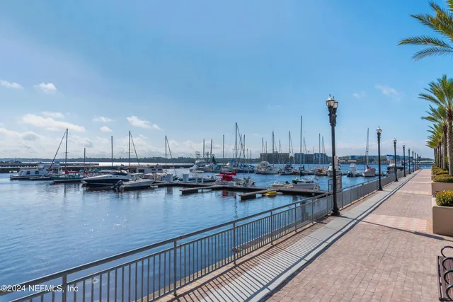 a view of a tall building with a palm tree and a yard