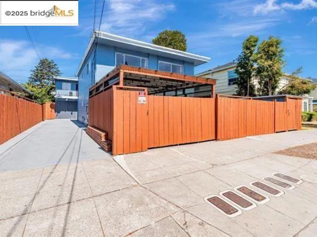 a view of a room with a wooden floor and stairs
