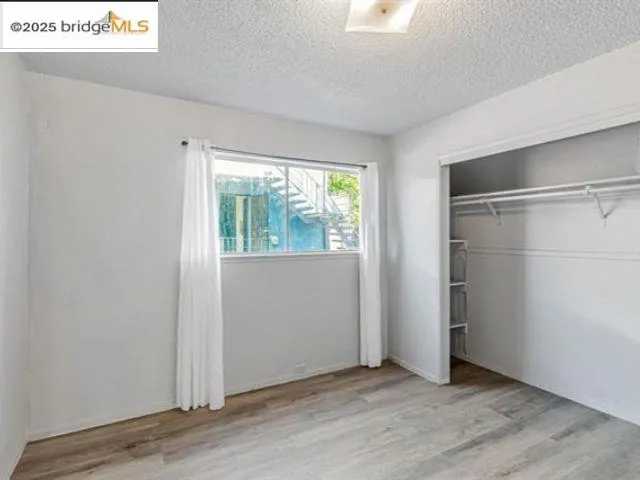 a kitchen with granite countertop white cabinets and a sink