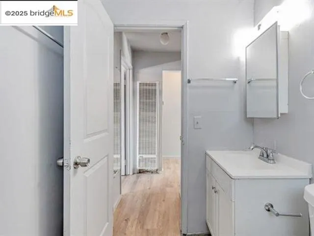 a view of a room with wooden floor and a window