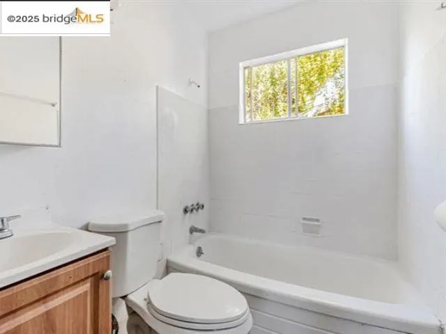 a view of a pathway with a wooden fence