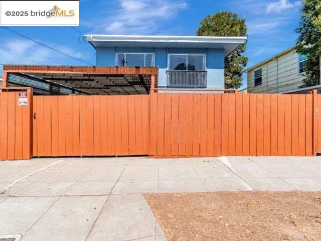 a kitchen with a sink a stove a refrigerator and white cabinets