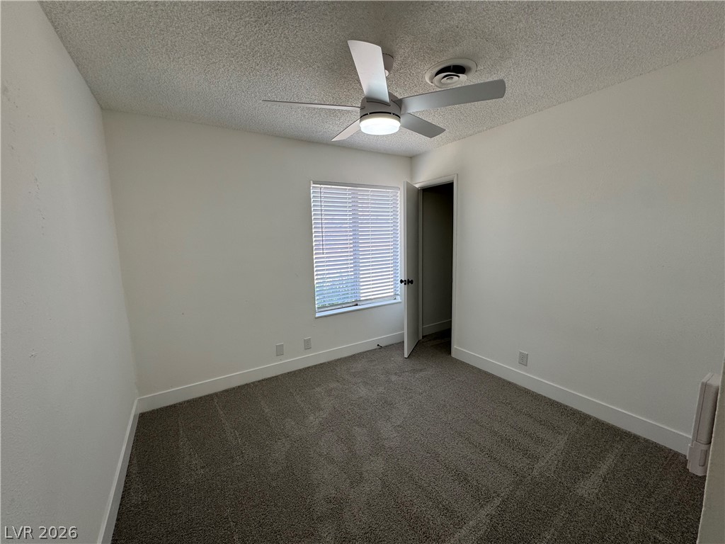 4048 Maple Hill Road Las Vegas, NV 89115 - Photo 28 of 40 1st bedroom or office with walk in closet. New ceiling fan, carpet, and window blinds.
