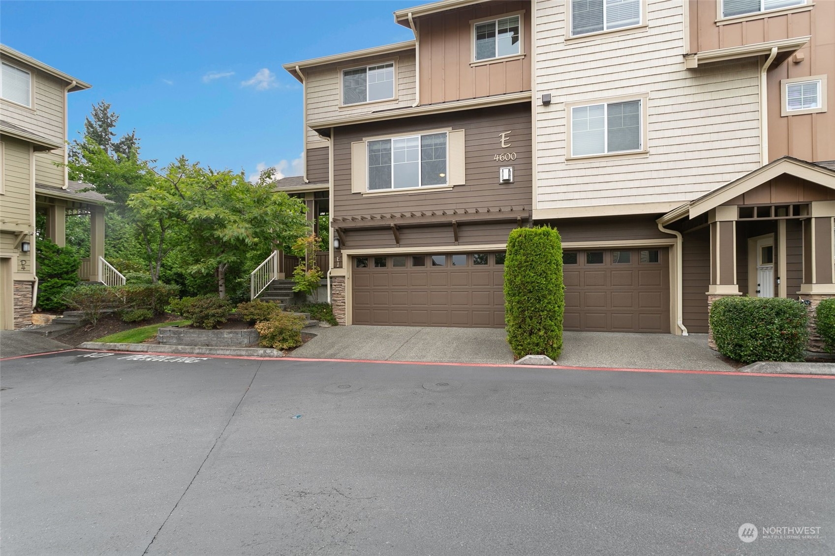 4600 Northeast 3rd Lane, Unit E1 Renton, WA 98059 - Photo 1 of 35 a view of a house with a yard and garage
