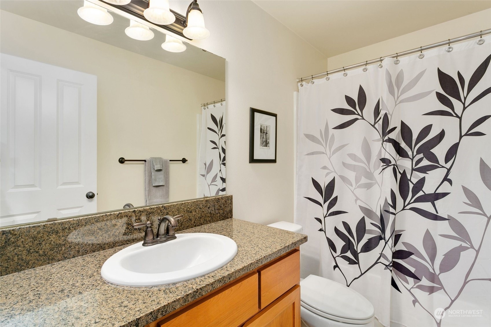 4600 Northeast 3rd Lane, Unit E1 Renton, WA 98059 - Photo 29 of 35 a bathroom with a granite countertop sink and a mirror