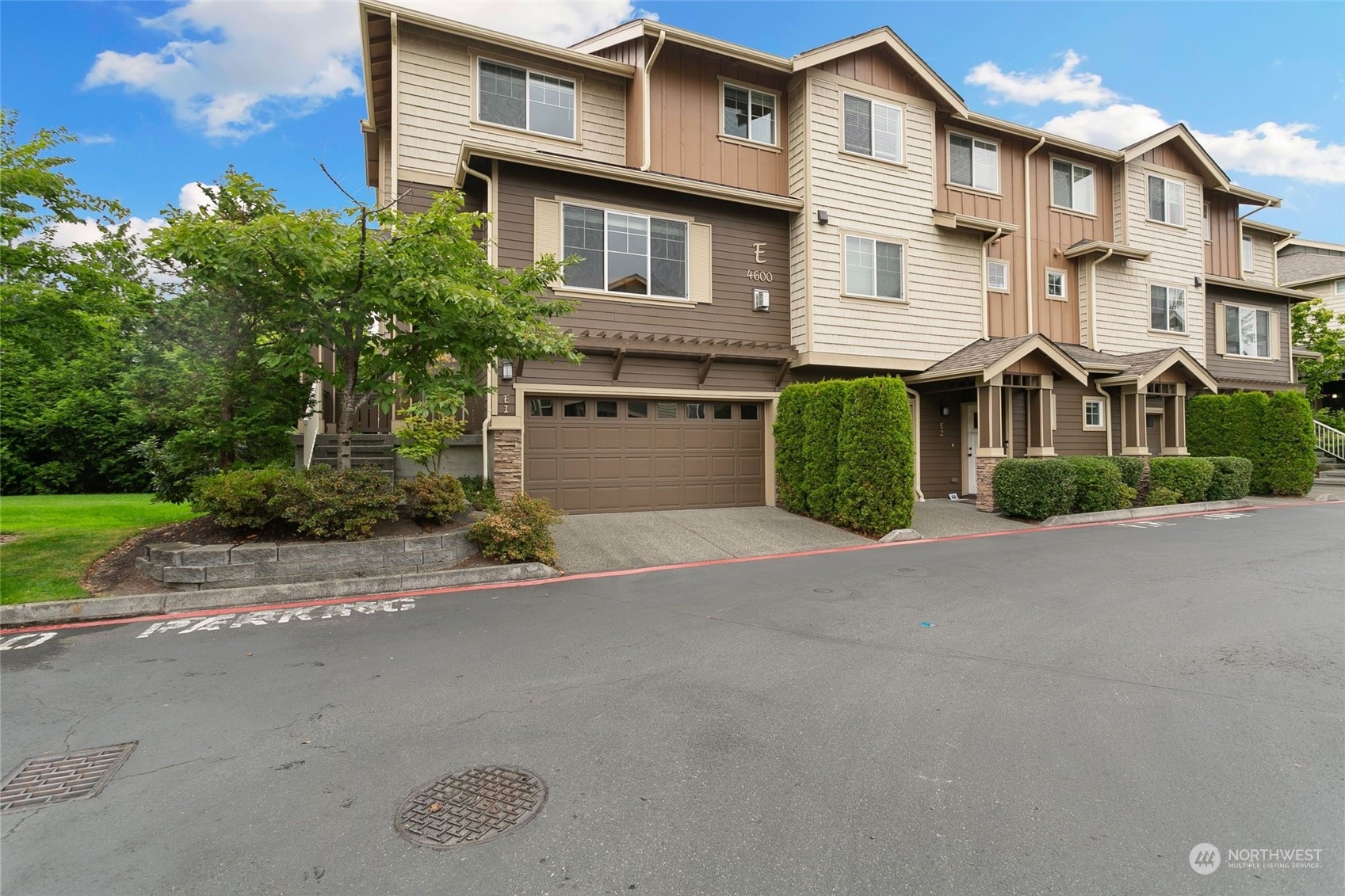 4600 Northeast 3rd Lane, Unit E1 Renton, WA 98059 - Photo 34 of 35 a front view of a house with a yard and a garage